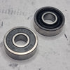 front and back of black shielded skate bearing