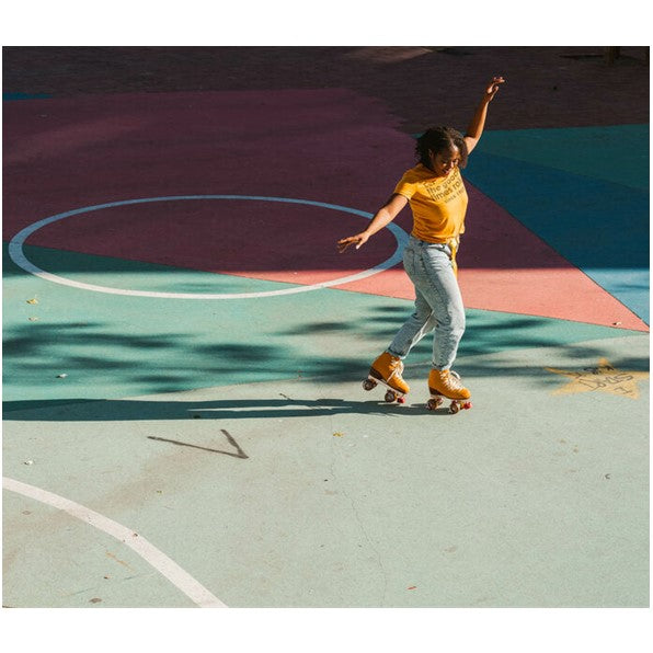 person at basketball court wearing orange suede high top roller skates