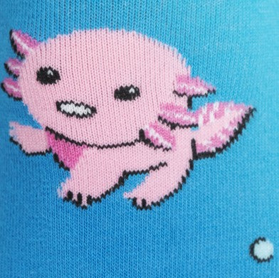 CLOSE UP OF PINK CARTOON AXOLOTL ON BLUE KNEE HIGH SOCK