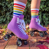 person wearing mid calf white socks with rainbow stripes and purple rollerskates 