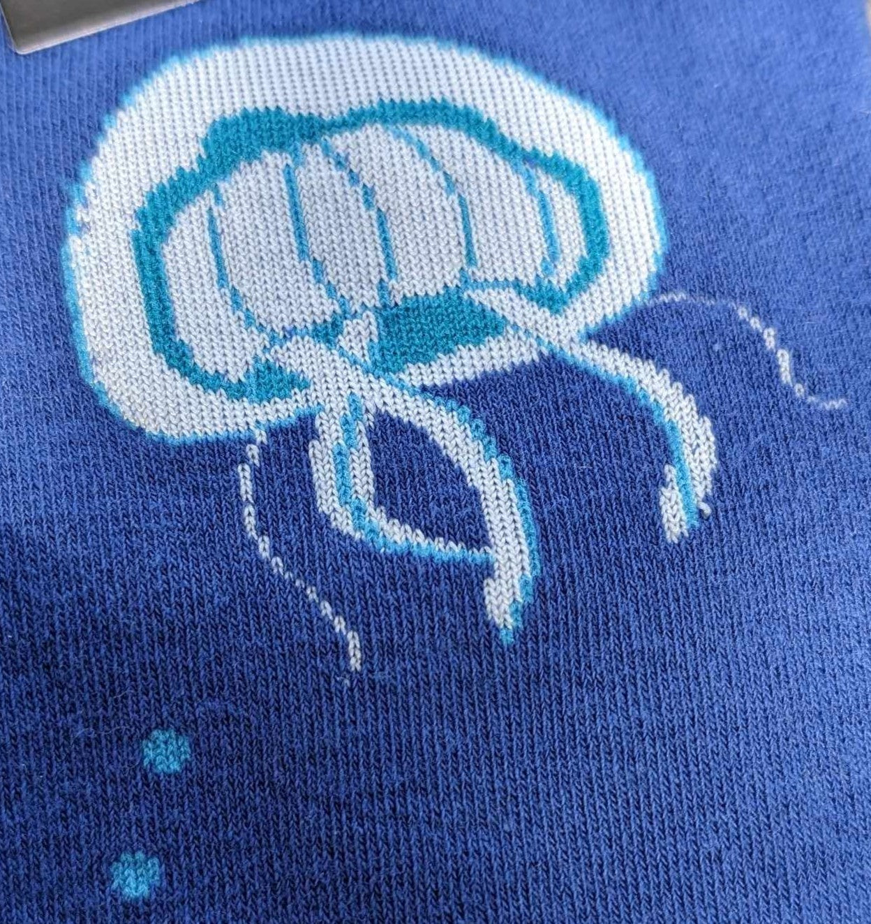 CLOSE UP OF BLUE JELLY FISH ON ROYAL BLUE SOCK