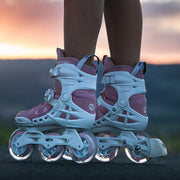 pink 3 wheeled inlione skates with white frames and white brake 