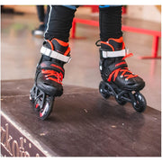 KID WEARING BLACK RED INLINE TRI SKATES