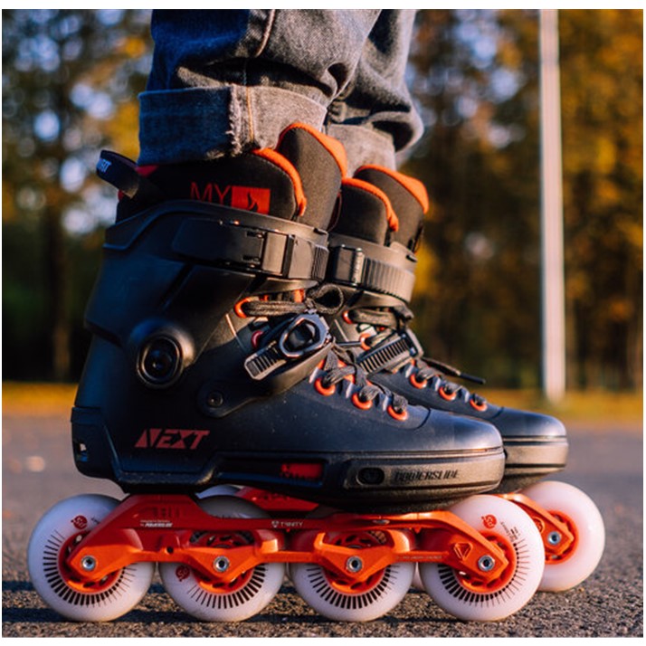 perosn wearing black and red urban inline skates 