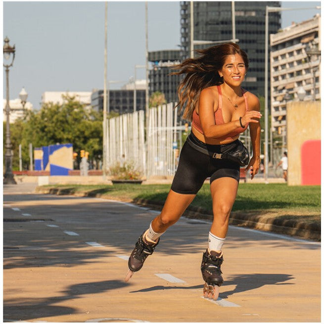 women wearing orange brown inline skates 