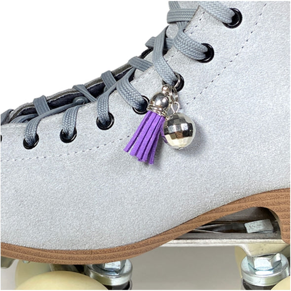 small disco ball with purple tassels attatched to rollerskate