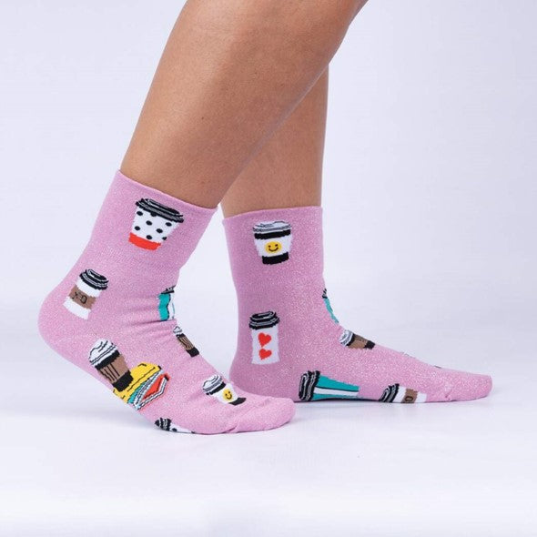 PERSON WEARING PINK CREW SOCKS WITH PATTERN OF COFFEE CUPS