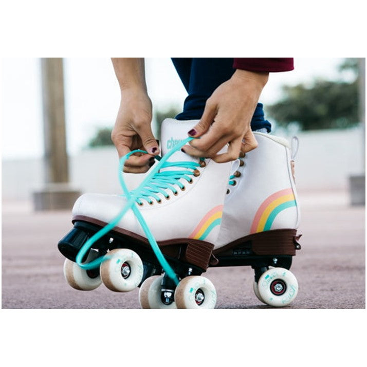 person lacing up chaya white pearl high top adjustable kids skate