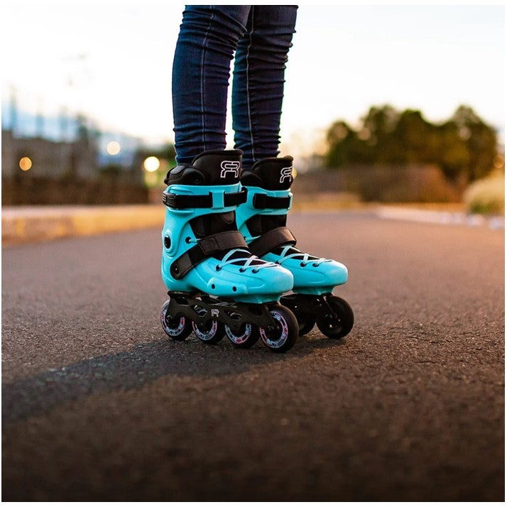 PERSON WEARING TEAL AQUA INLINE SKATES 