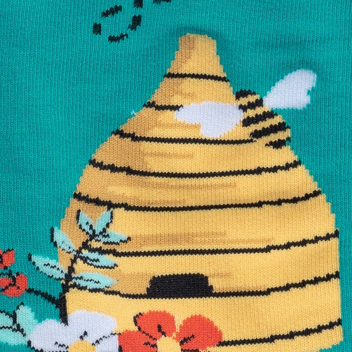 CLOSE UP OF BEE HIVE WITH FLOWERS ON SIDE OF TEAL SOCK