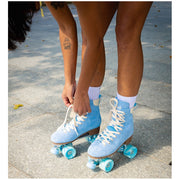 women bending over lacing up blue roller skates