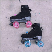 2 black rollerskates, one with pink luminious led wheels and one with blue glow luminious wheels 