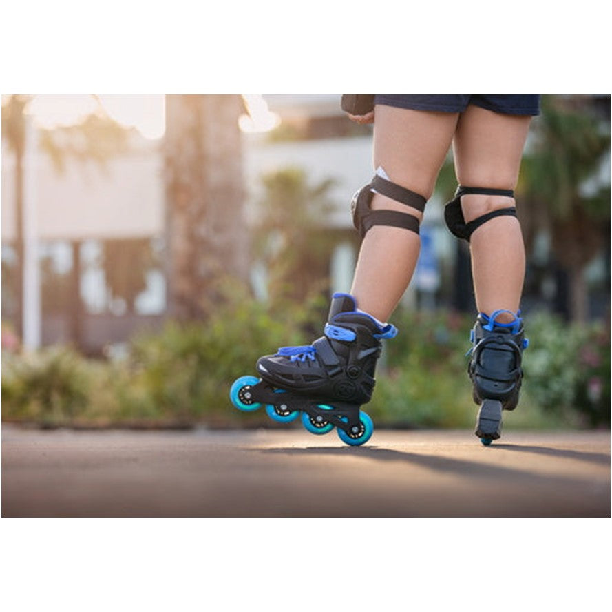 PERSON WEARING BLACK AND BLUE KIDS INLINE SKATES 