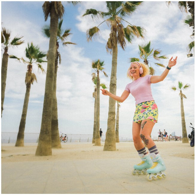 women wearing pastel green yellow inline skates 