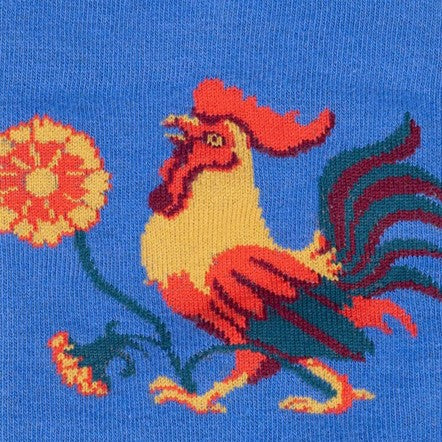 CLOSE UP OF YELLOW AND ORANGE ROOSTER ON BLUE KNEE HIGH SOCK