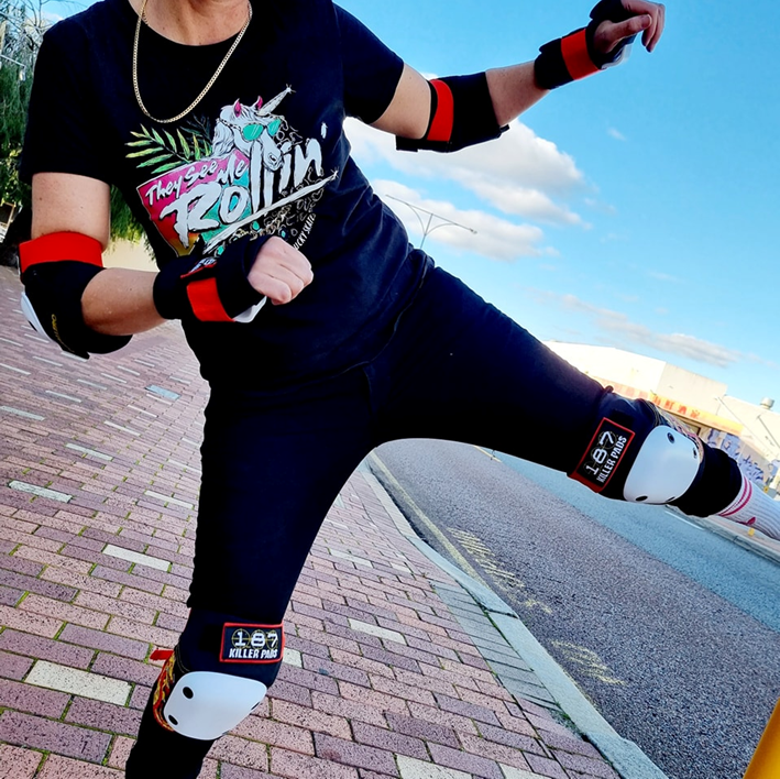 girl doing kick wearing dragon printed wrist elbow and knee pads