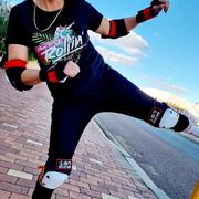 girl doing kick wearing dragon printed wrist elbow and knee pads