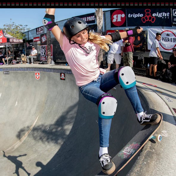 skateboarder wearing 187 pink and teal knee elbow and wrist guards