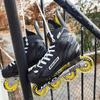 bauer yellow rs street roller hockey skates hanging on fence 