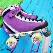 purple high top skate with street flow wheels against a colourful brick wall