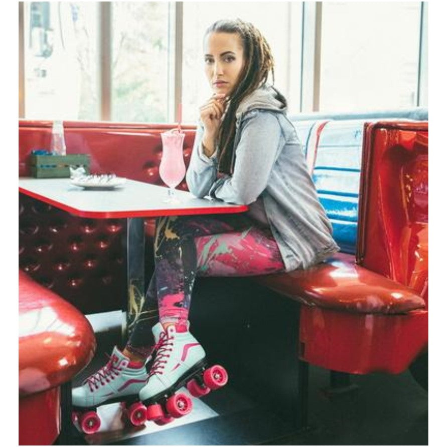 person wearing aqua pink sneaker roller skate pink outdoor wheels in a cafe