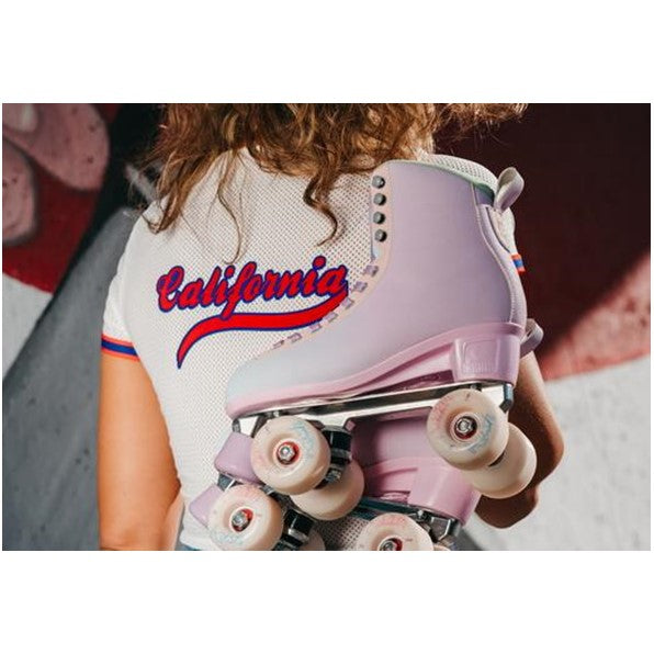 person with chaya pastel high top roller skates thrown over shoulder