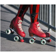 person at fence wearing red chaya high top roller skates