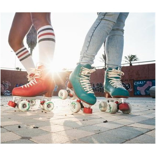 people wearing hight top red and green chaya roller skates at skate park