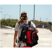 man with black red chaya backpack over his shoulder 