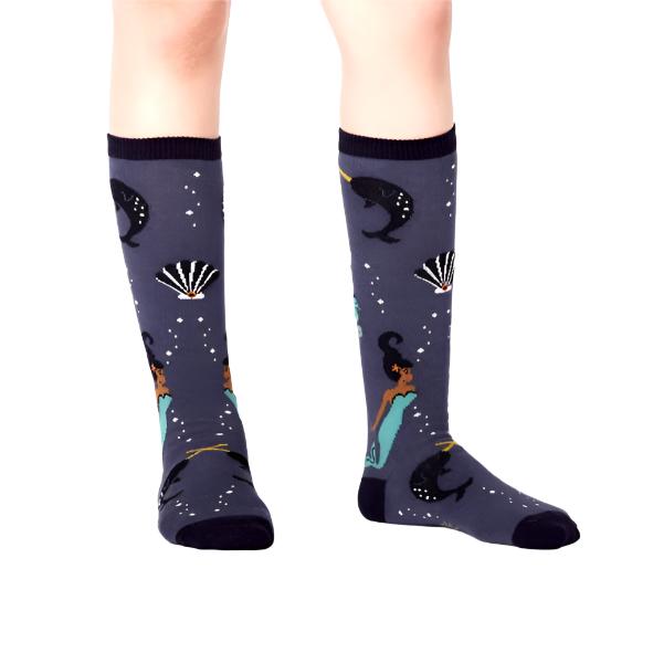 kid wearing dark blue knee high socks mermaid narwhale shell pattern