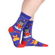 PERSON WEARING ROYAL BLUE CREW SOCKS WITH GREY KITTEN AS PAPER DOLL CUTOUT WITH CLOTHES 