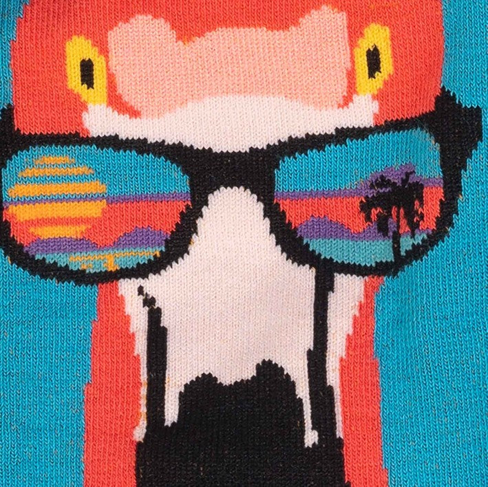 CLOSE UP OF BRIGHT BLUE KNEE HIGH SOCKS WITH LARGE PINK FLAMINGO HEAD ON SIDE WEARING SUN GLASSES