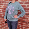 WOMENS WEARING SAGE GREEN TEE WITH PINK LOGO OF PINEAPPLE WEARING ROLLER SKATES lucky skates roll with it 