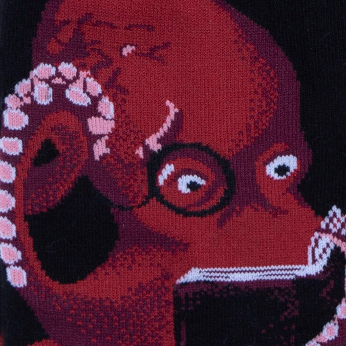 CLOSE UP OF RED OCTOPUS READING ON SOCK