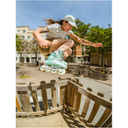 women jumping while waering pastel green inline skates 