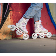 person wearing white and pink purple 3 wheel inline skates