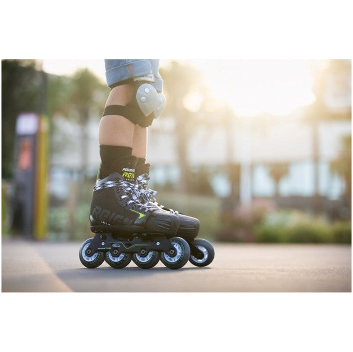 KID WEARING BLACK INLINE ROLLER HOCKEY SKATES