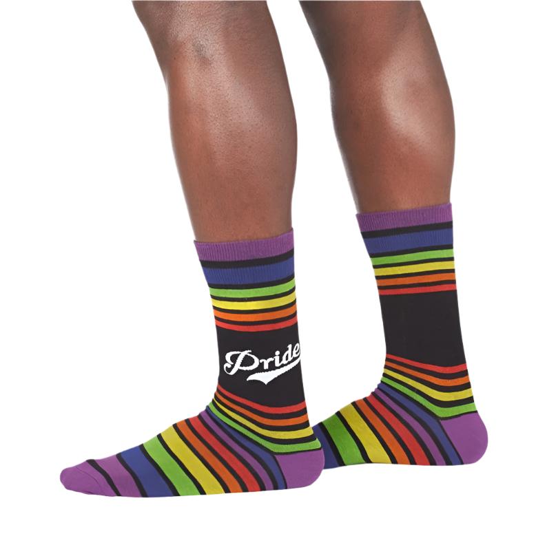 PERSON WEARING RAINBOW STRIPE CREW SOCKS WITH TEXT "PRIDE"