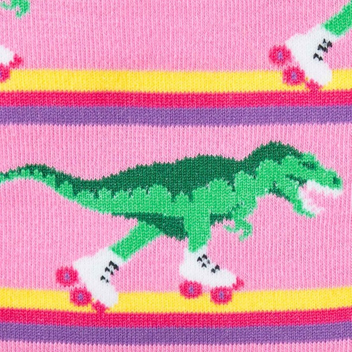 close up of green dinosaur roller skating on pink knee high sock