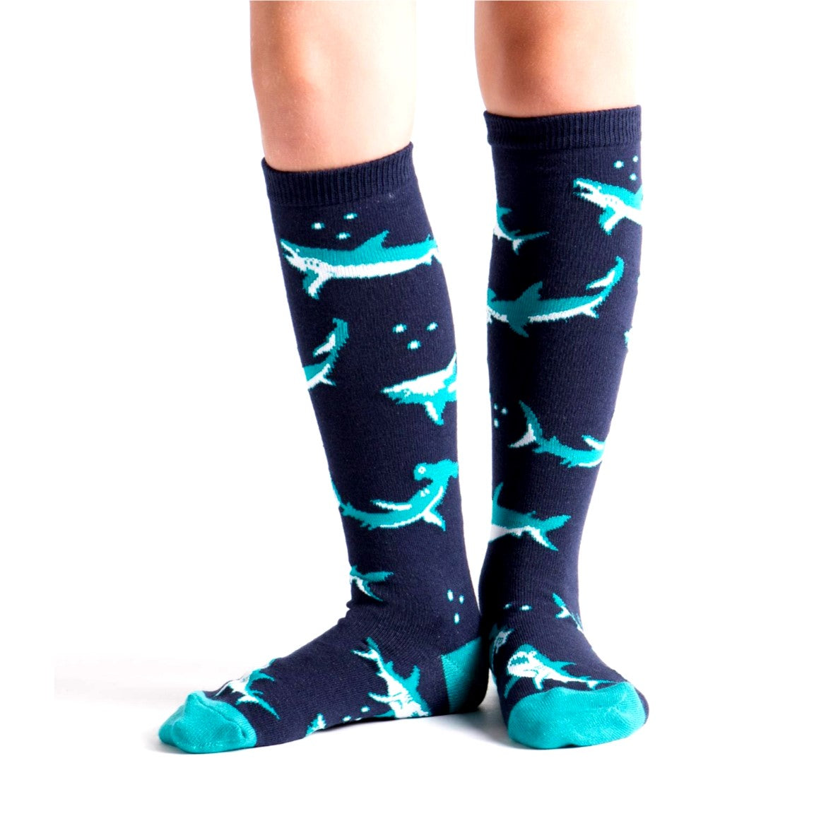 PERSON WEARING NAVY BLUE JUNIOR KNEE HIGH SOCKS WITH SHARK PATTERN