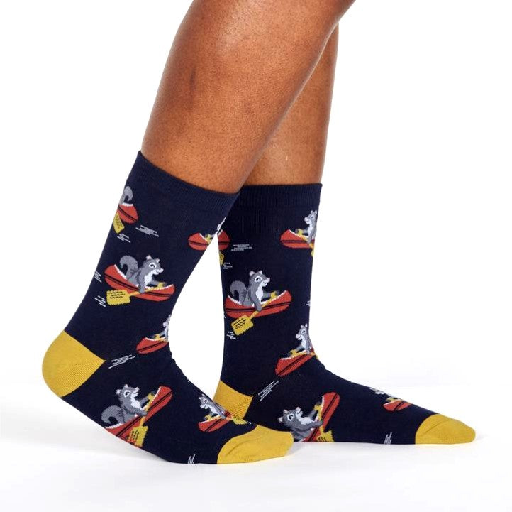 PERSON WEARING NAVY BLUE CREW SOCKS WITH YELLOW HEEL AND TOE WITH PATTERN OF GREY SQUIRREL ROWING A BOAT