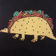 CLOSE UP OF TACO DINOSAUR ON BLACK SOCK