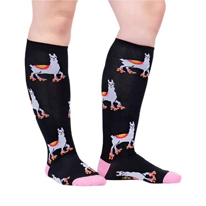 PERSON WEARING BLACK KNEE HIGH SOCKS WITH LLAMAS SKATING