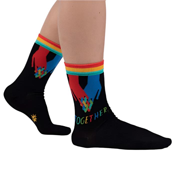 PERSON WEARING BLACK CREW SOCK WITH RED AND BLUE HANDS HOLDING AND TEXT BELOW "TOGETHER"