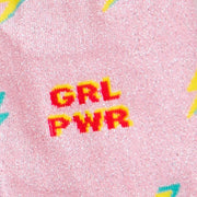 CLOSE UP OF LIGHT PINK CREW SOCKS WITH LIGHTENING BOLTS AND TEXT "GRL PWR"