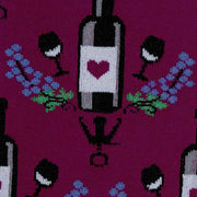 CLOSE UP OF WINE BOTTLE AND GLASSES WITH PURPLE FLOWERS PATTERN ON SOCK