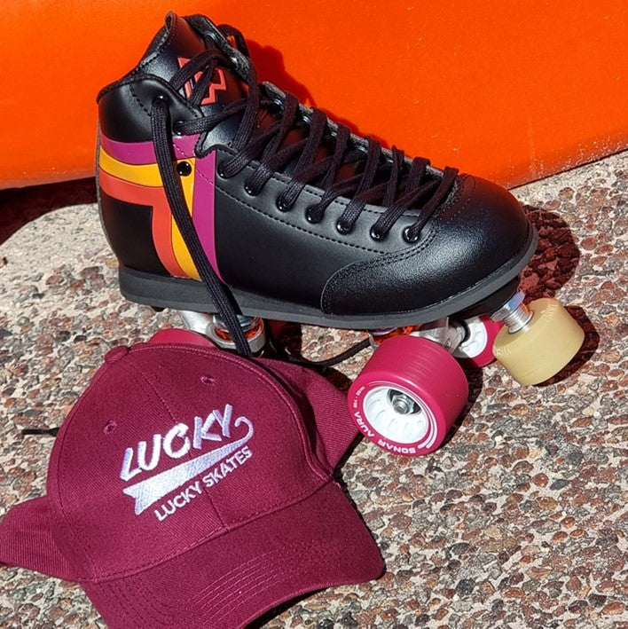 black antik rollerskate with red yellow orange stripe and maroon hat