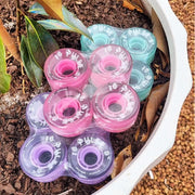 atom pulse wheels pink teal mint sitting in pot 