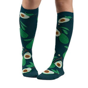 PERSON WEARING GREEN KNEE HIGH SOCKS WITH AVACADO PATTERN