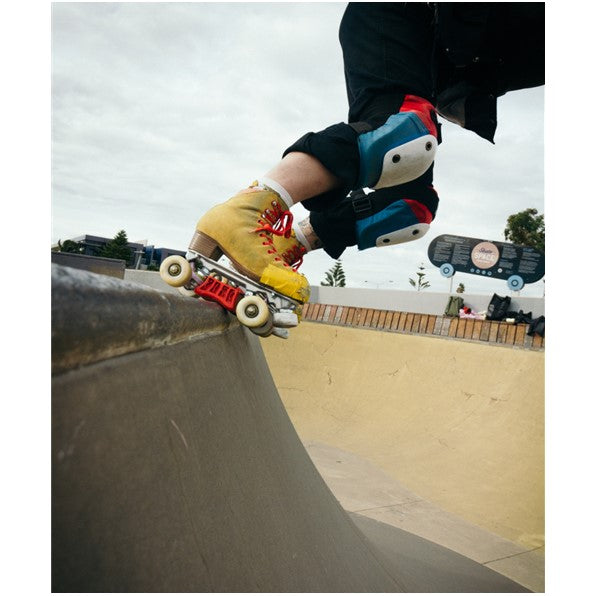 red grind block on yellow skates at skate park